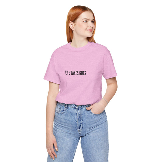 Person wearing a pink t-shirt with 'LIFE TAKES GUTS' text on a white background