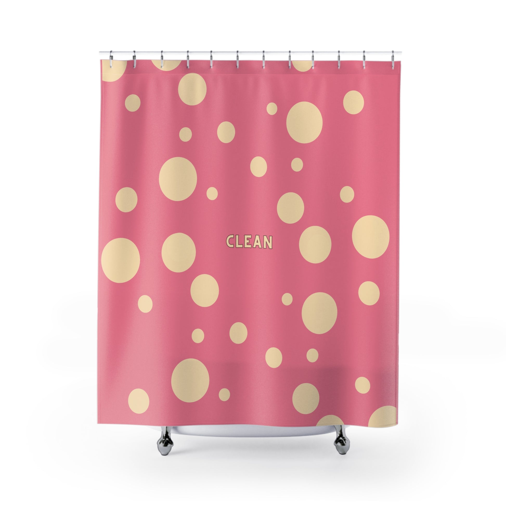 Pink shower curtain with a pattern of beige polka dots and the word 'CLEAN' printed in the center, shown hanging from silver rings on a white background.