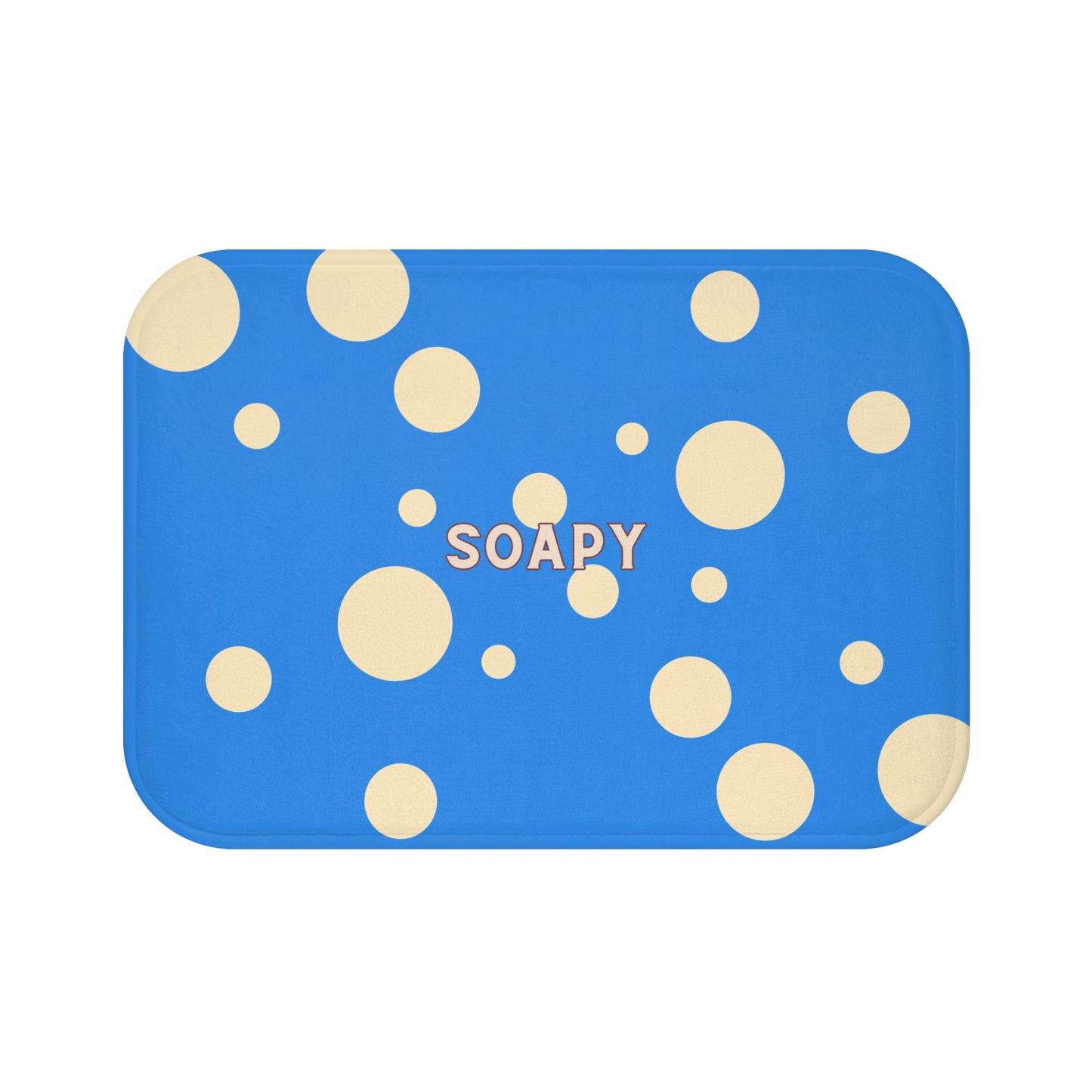 A rectangular blue bath mat with rounded corners, decorated with scattered beige polka dots and the word 'SOAPY' printed in the center.