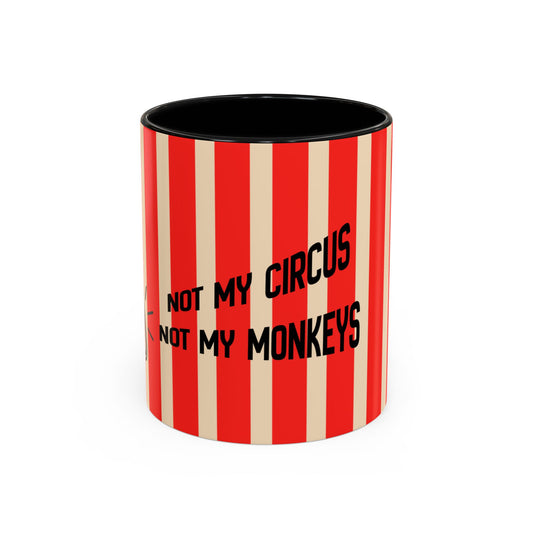 A cylindrical mug with a red and cream vertical stripe pattern, featuring the black text 'NOT MY CIRCUS NOT MY MONKEYS' on the front. The mug has a solid black interior and is photographed on a clean white background.