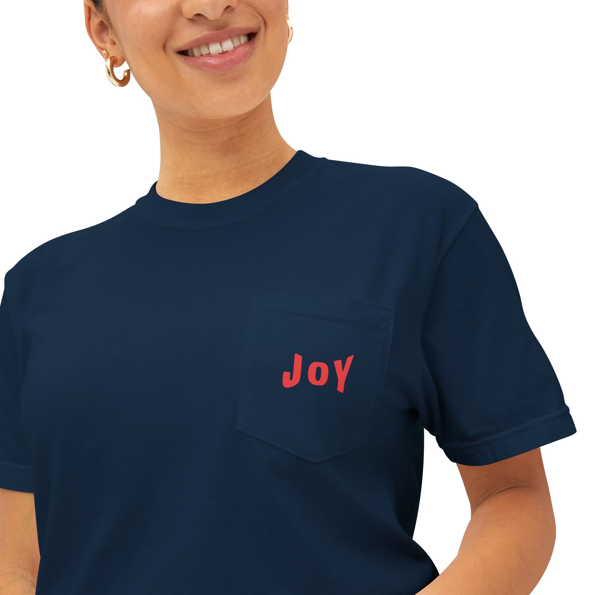 Person wearing a navy blue t-shirt with 'JOY' in red on a white background