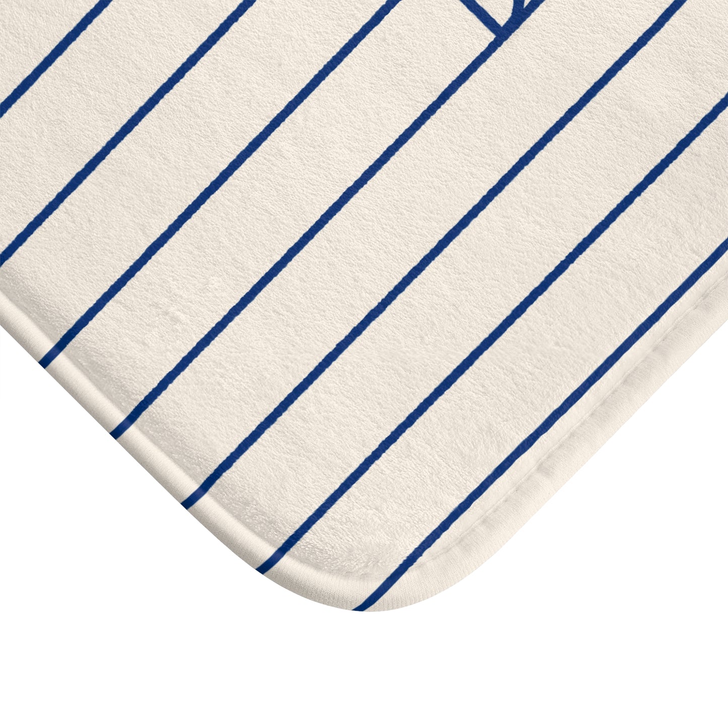 A close-up of a white or off-white fabric product with thin, evenly spaced blue pinstripes, showing a rounded corner and part of a stitched edge.