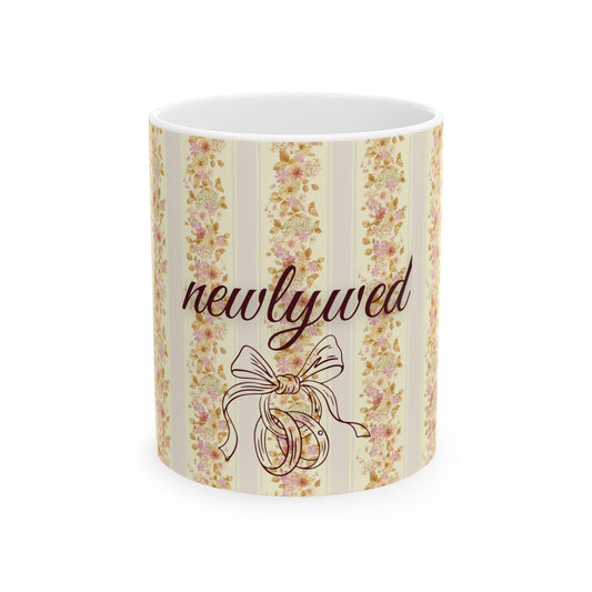 Mug with floral design and 'newlywed' text on a white background