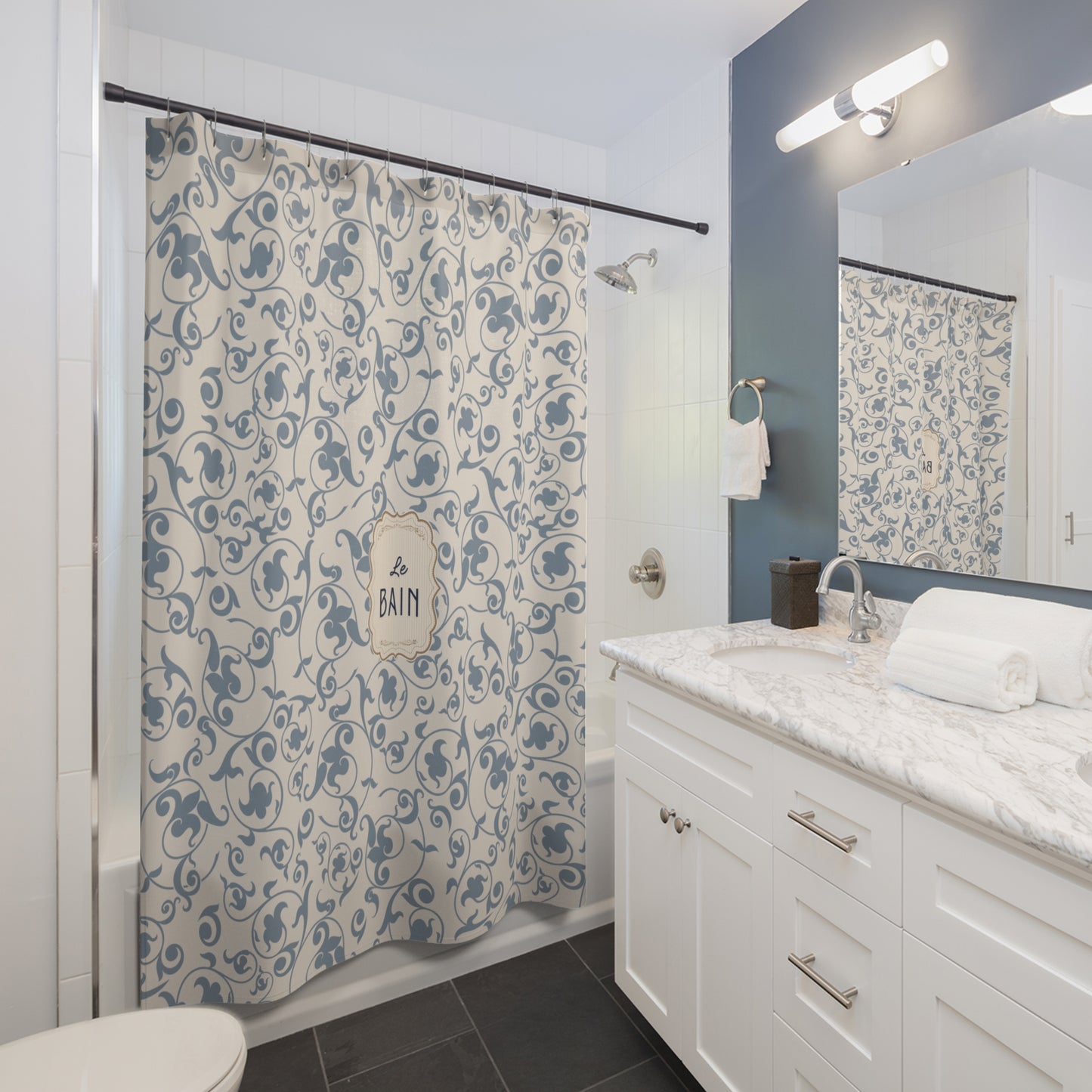 Bathroom with a patterned shower curtain, sink, and mirror.