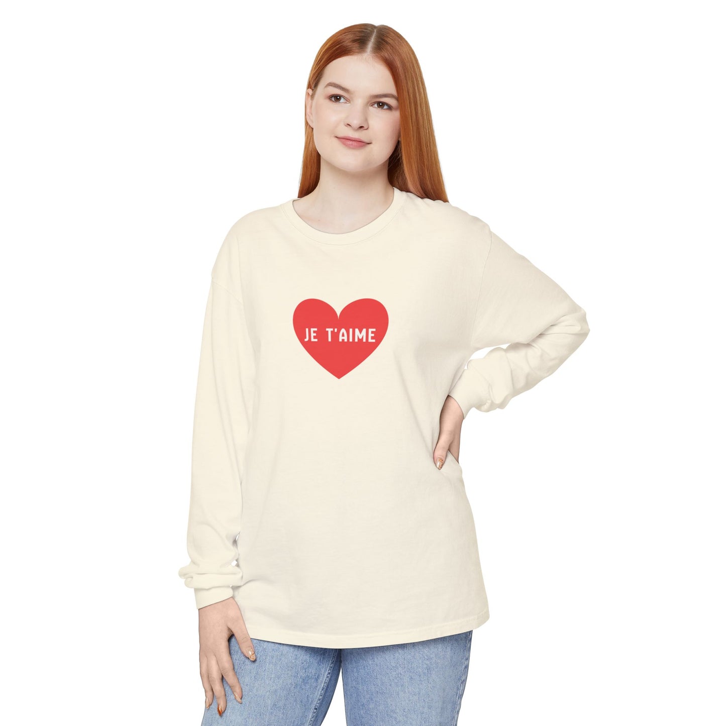 Woman wearing a cream long-sleeve shirt with a red heart and 'JE T'AIME' text on a white background