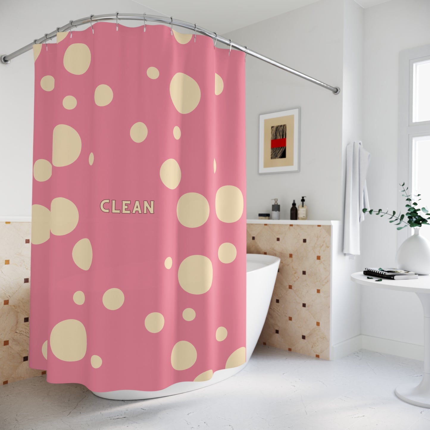 A pink shower curtain with a beige polka dot pattern and the word 'CLEAN' printed in the center, hanging in a bright, modern bathroom next to a bathtub.