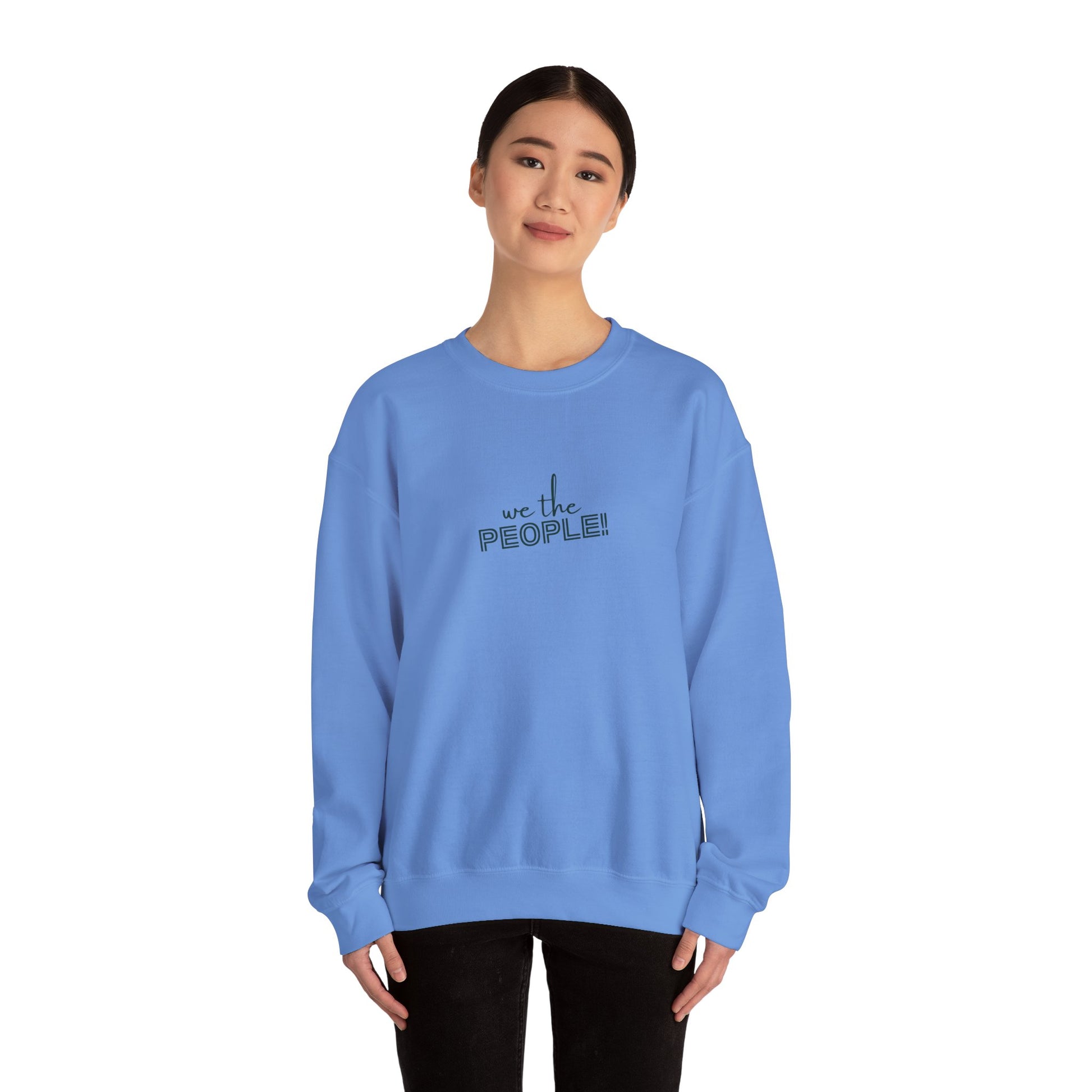 Person wearing a blue sweatshirt with 'we the people!' text on a white background