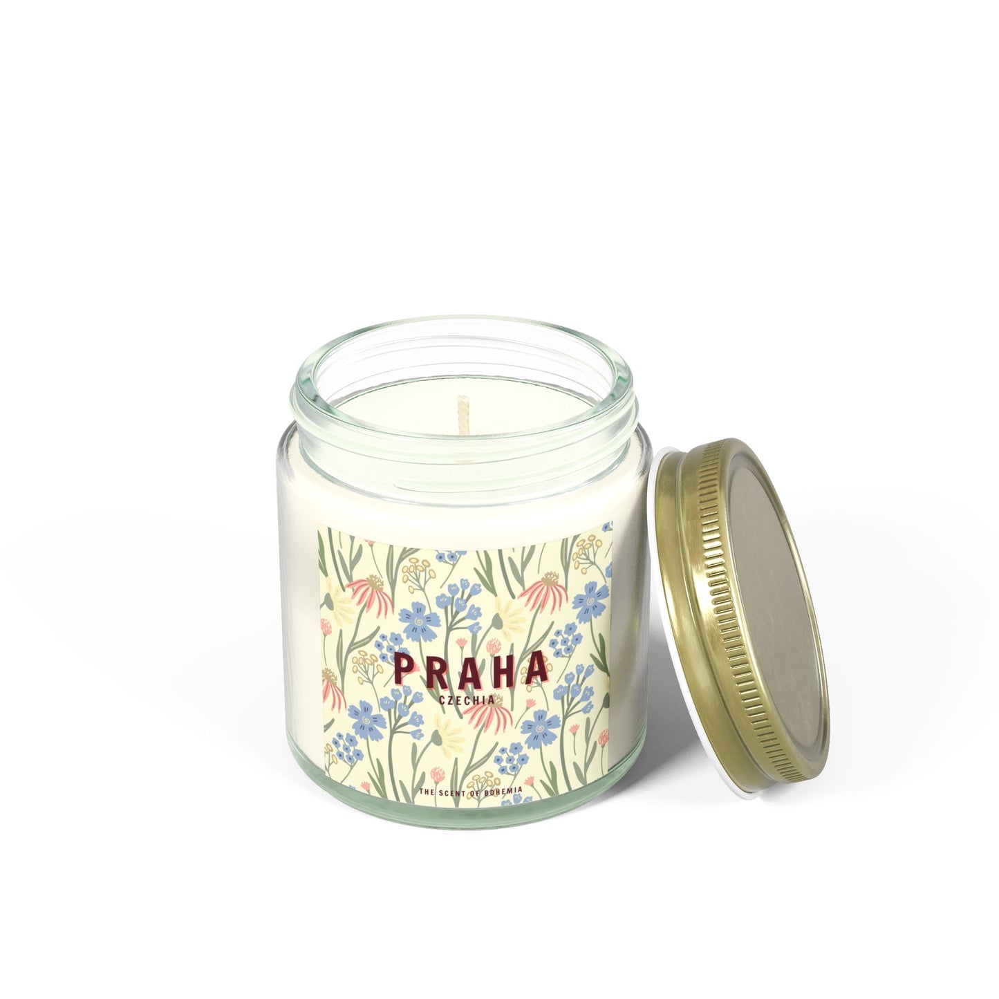 Candle in a glass jar with floral design and 'Praha' text on a white background