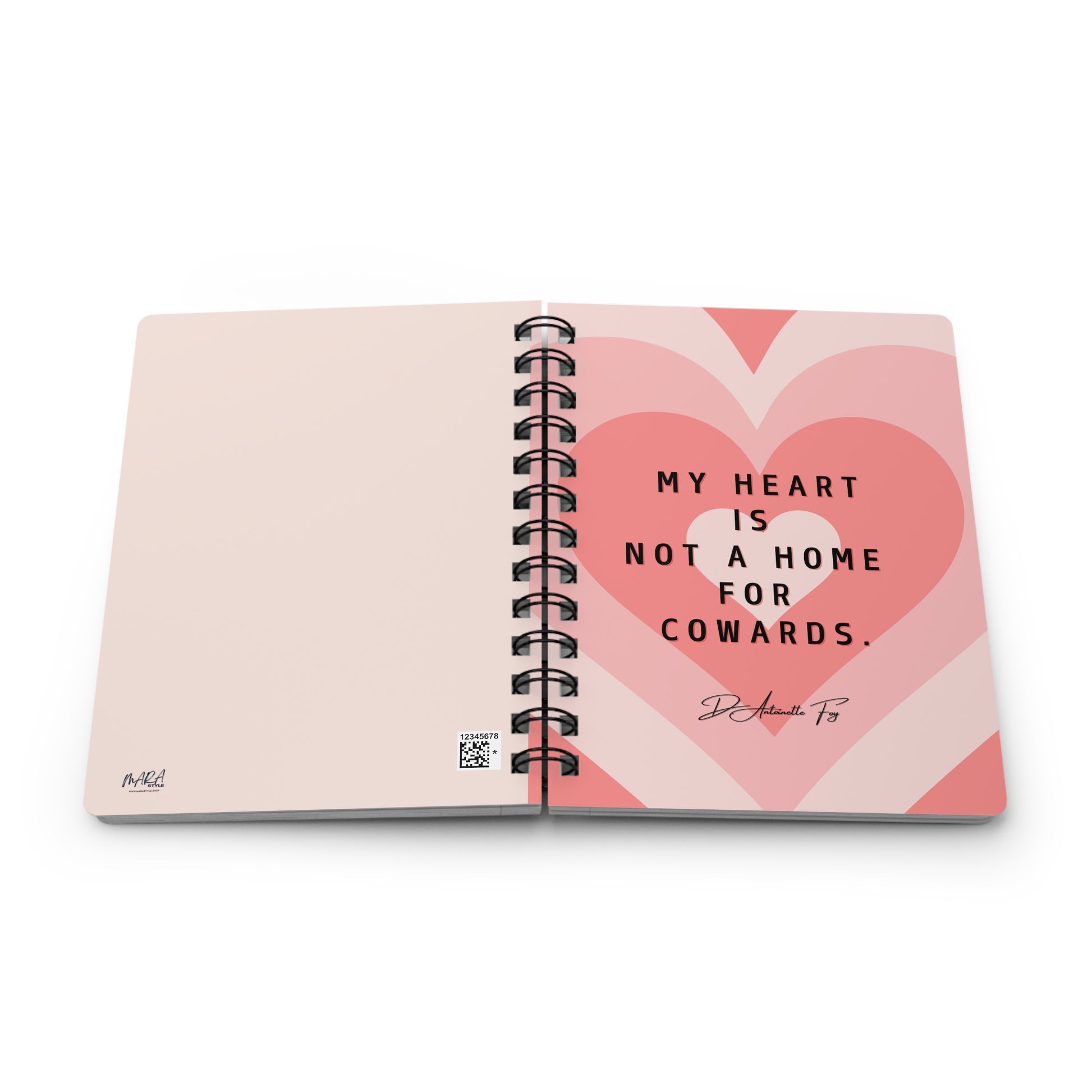 Open notebook with pink heart design and motivational quote on a white background