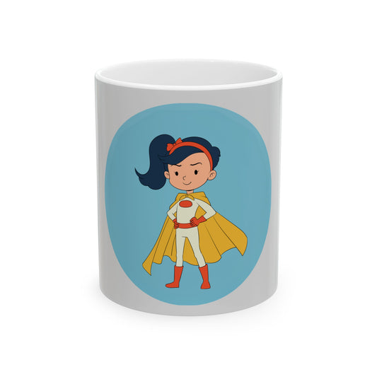 A white ceramic mug featuring a cartoon illustration of a superhero girl with a yellow cape, red outfit, and blue circular background, shown on a clean white studio background.