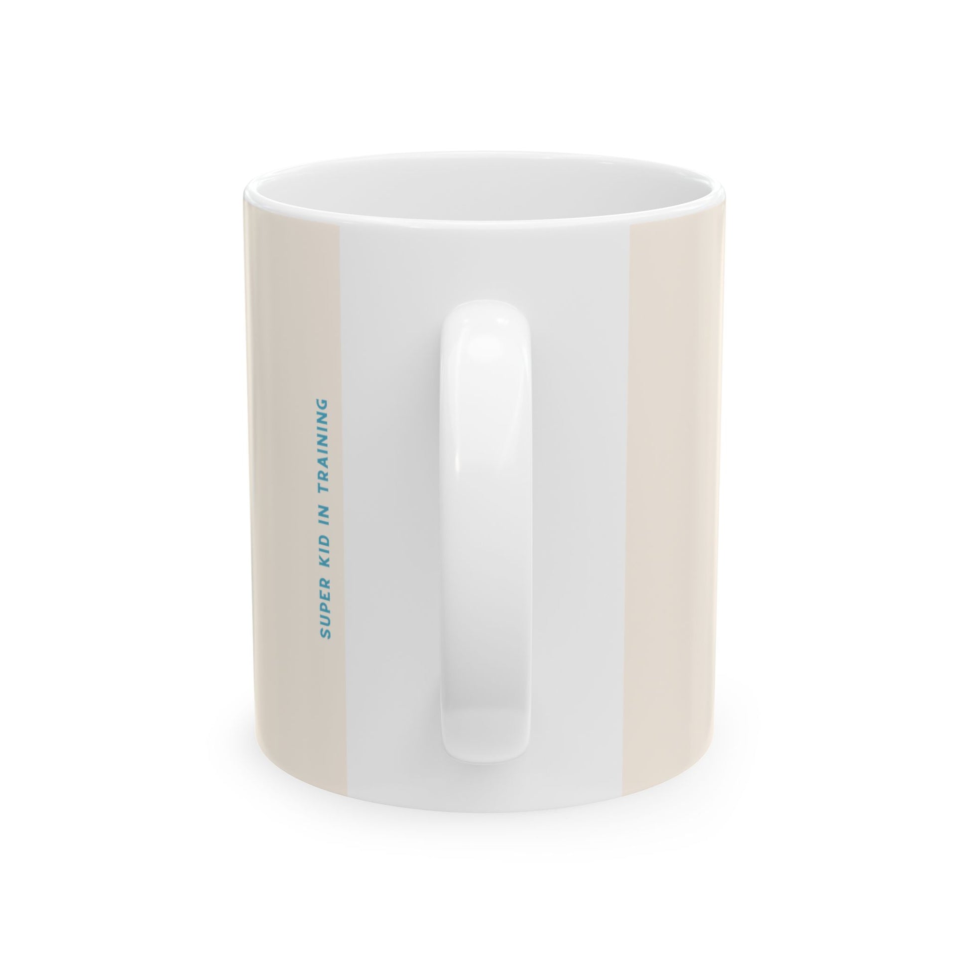 A white ceramic mug with a vertical beige stripe on the left side and blue text reading 'SUPER KID IN TRAINING' printed on it, shown against a plain white background.