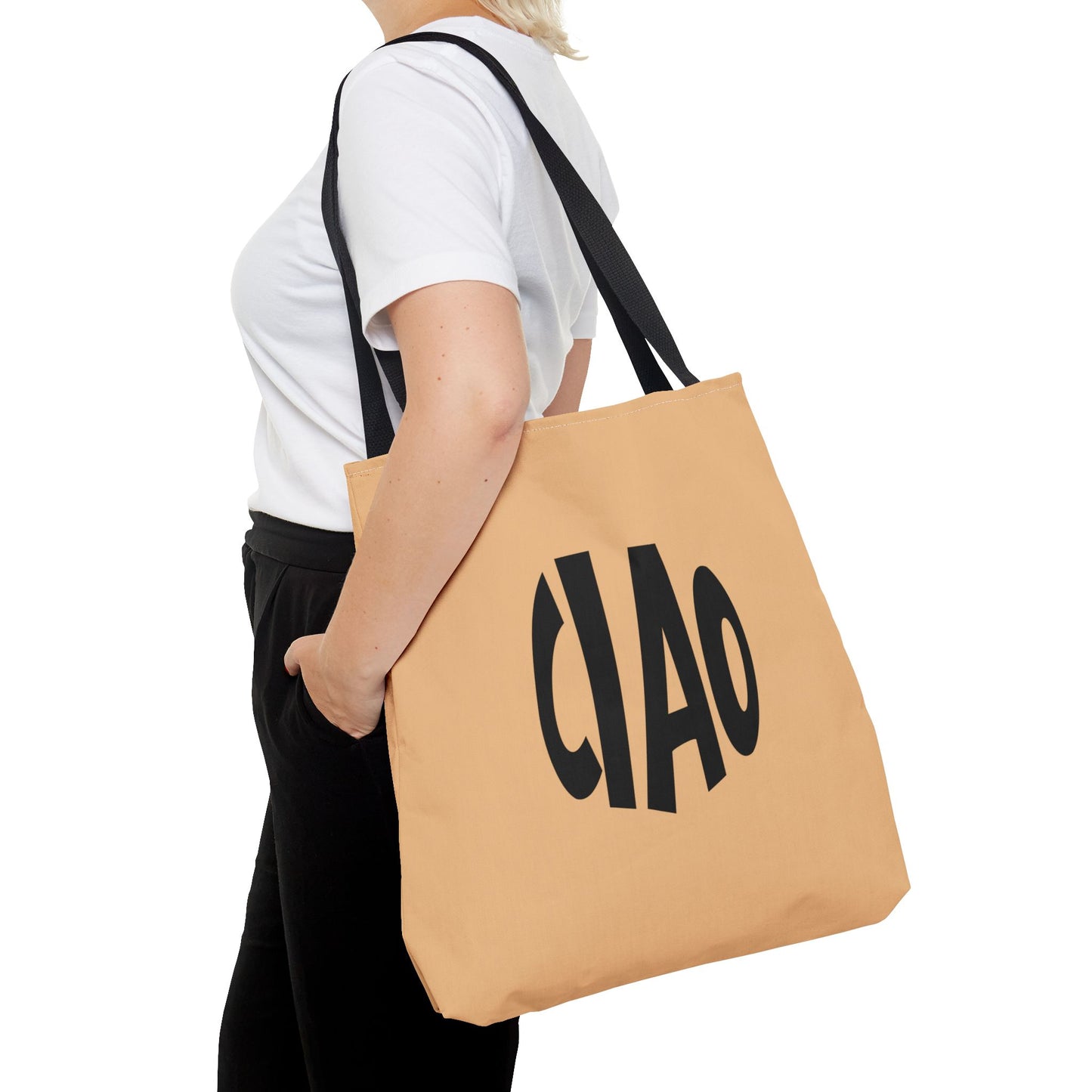 Person holding a beige tote bag with 'CHAO' printed on it against a white background