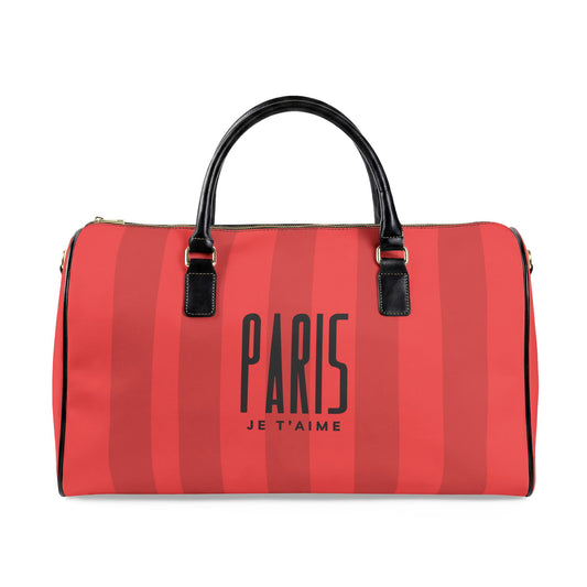 A red and pink striped duffle bag with black handles and gold-tone hardware, featuring the text 'PARIS JE T'AIME' printed on the front.