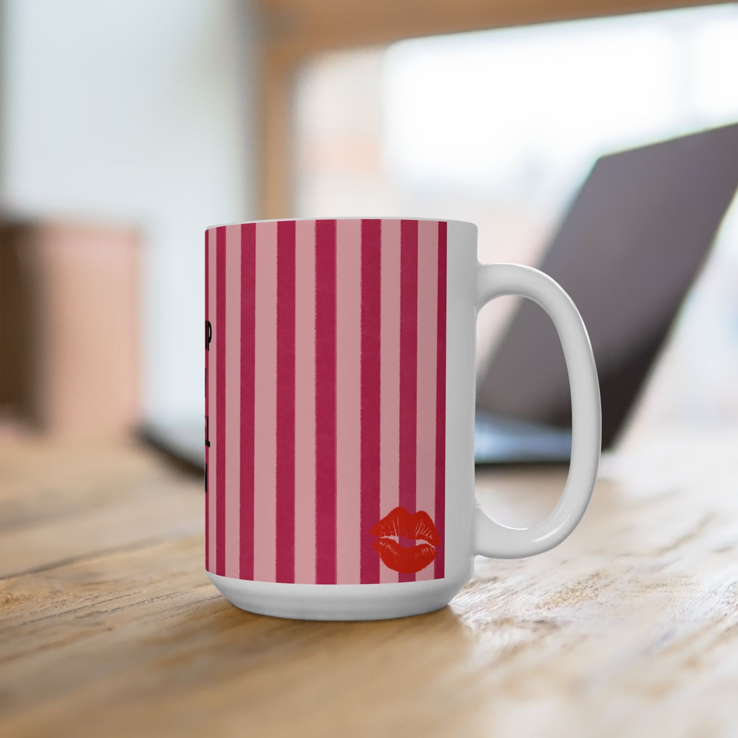 White mug with red striped pattern on a wooden surface