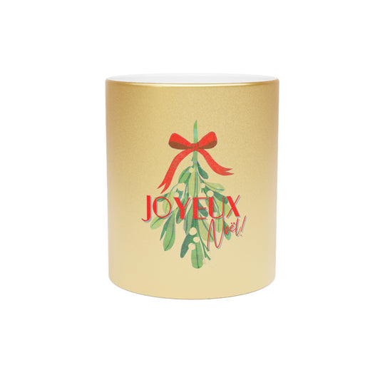Decorative candle with mistletoe and 'JOYEUX NOEL' text on a gold background