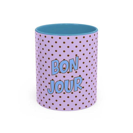 Purple mug with gold polka dots and blue interior, featuring 'Bonjour' text.
