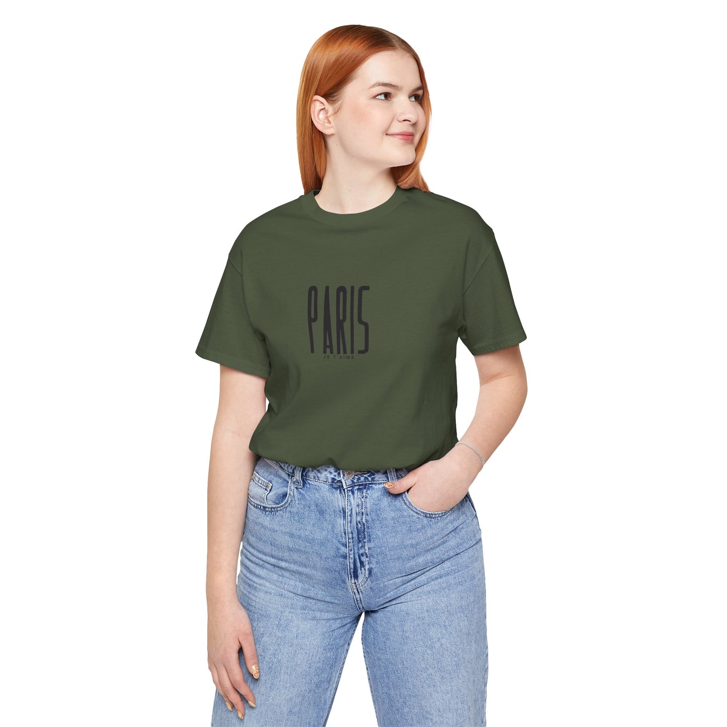 Person wearing a green t-shirt with 'PARIS' text and blue jeans on a white background