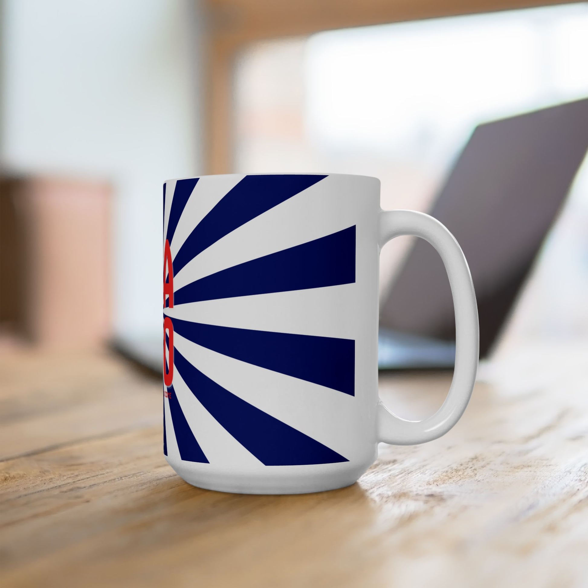 White mug with blue and red design on a wooden surface