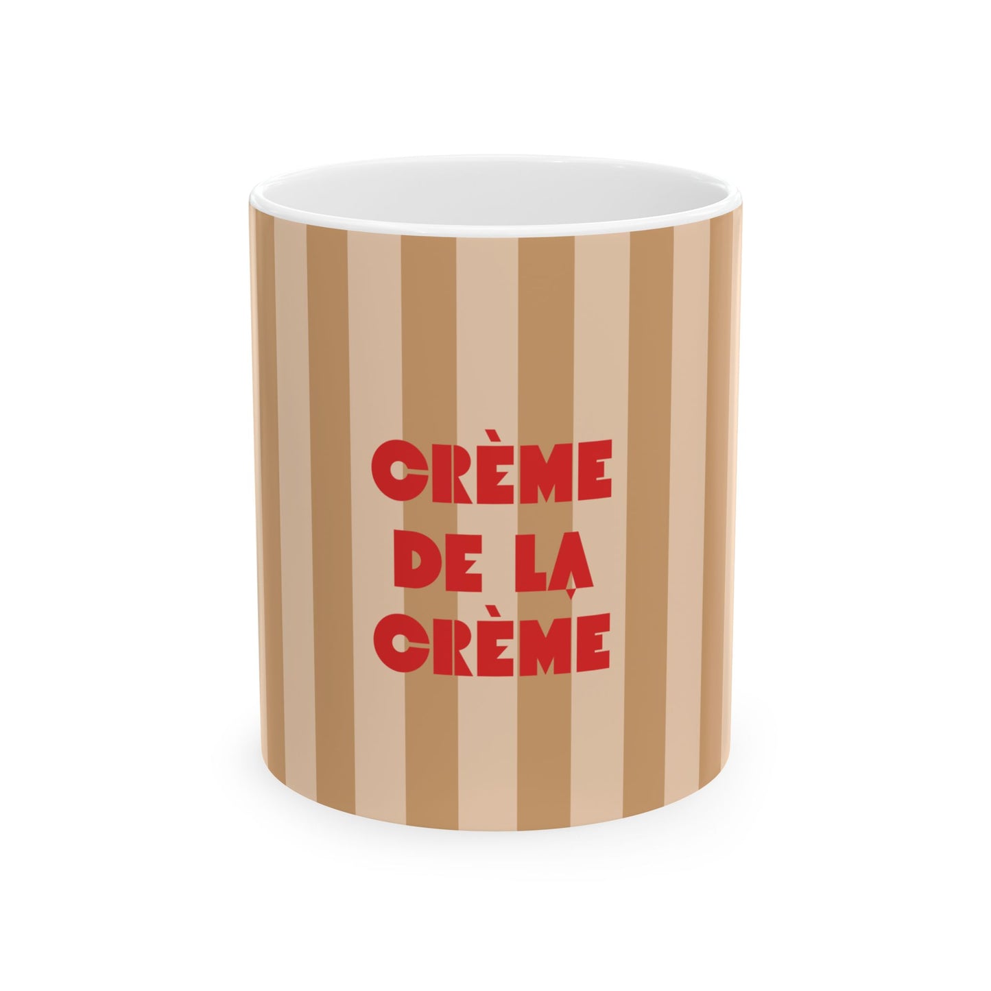 A cylindrical mug with vertical beige and light brown stripes, featuring the French phrase 'CRÈME DE LA CRÈME' printed in bold red letters on the front, set against a plain white background.