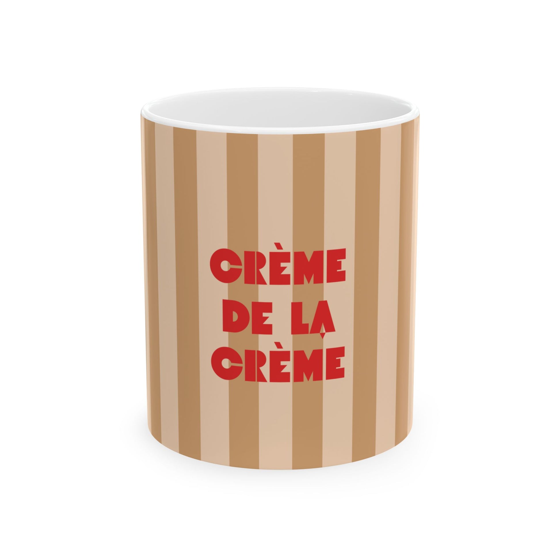 A cylindrical mug with vertical beige and light brown stripes, featuring the French phrase 'CRÈME DE LA CRÈME' printed in bold red letters on the front, set against a plain white background.