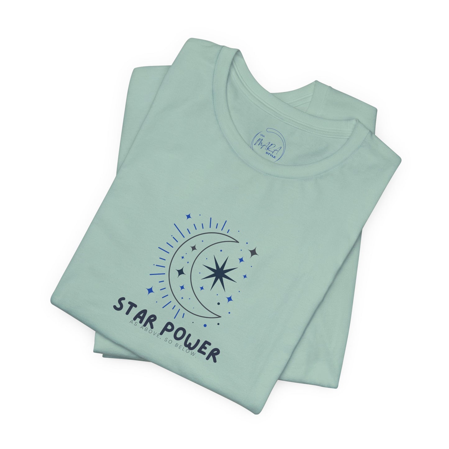 A folded mint green t-shirt with a dark blue graphic of a crescent moon, stars, and the text 'STAR POWER' on the front, set against a plain white background.