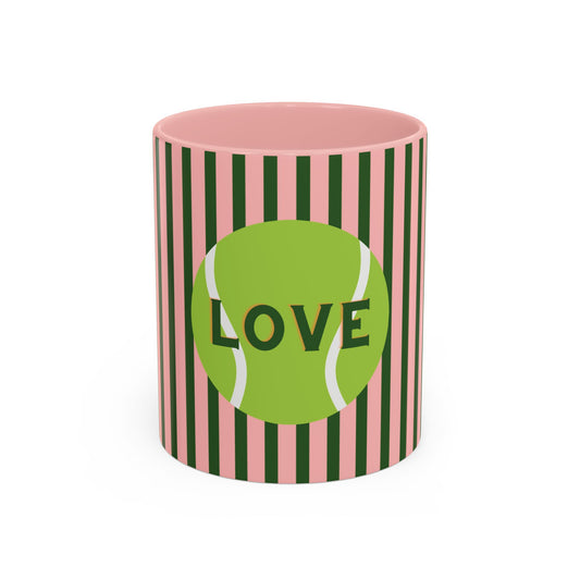 Ceramic mug with pink top and green and black striped sides, featuring a tennis ball design with 'LOVE' text.