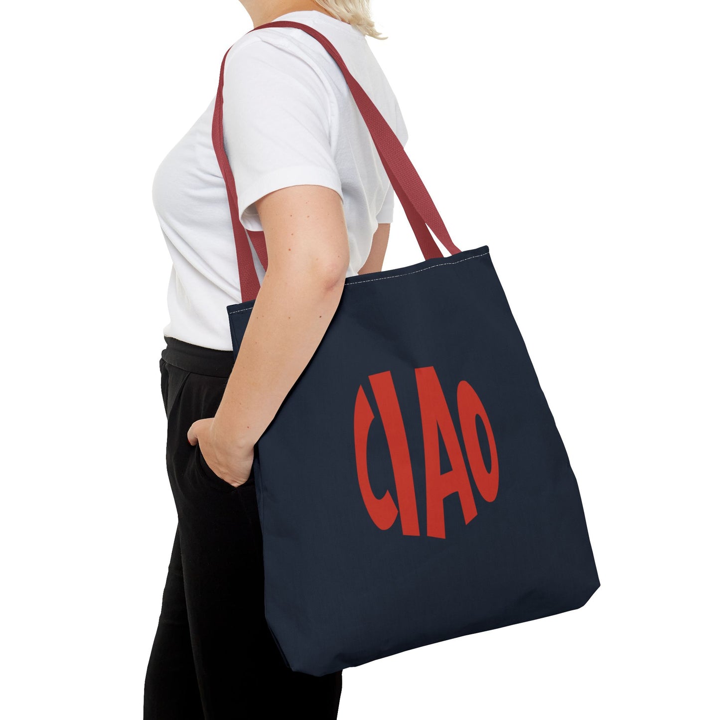 Person holding a navy tote bag with 'CIAO' in red text on a white background