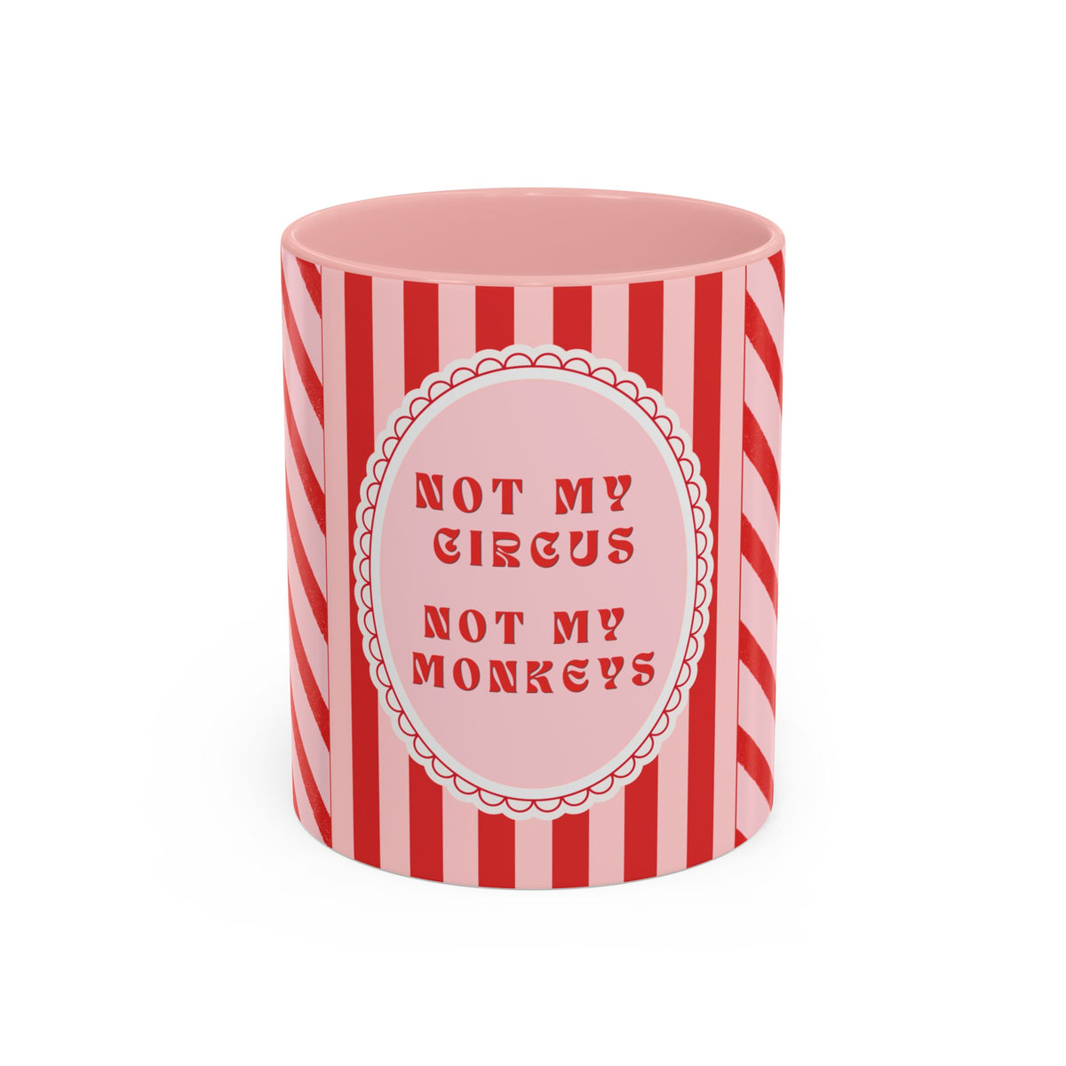 A pink and red striped ceramic mug with a circular label that reads 'NOT MY CIRCUS NOT MY MONKEYS' in red text, shown on a plain white background.