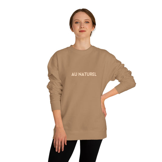 Woman wearing a beige sweatshirt with 'AU NATUREL' text on a white background