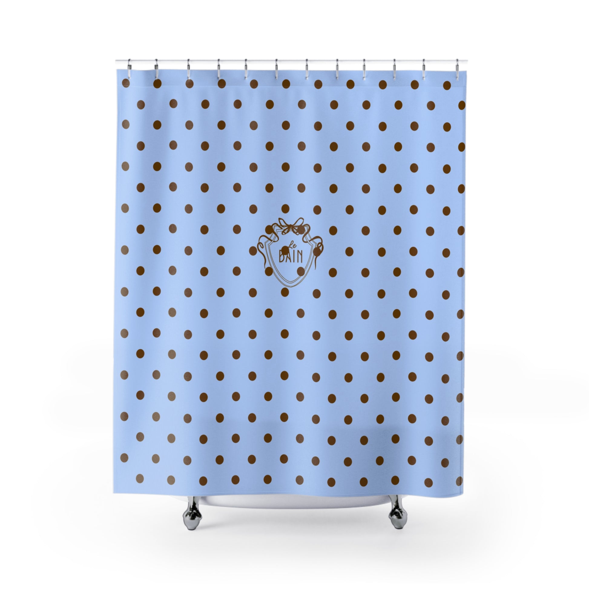 Shower curtain with blue background and brown polka dots featuring a logo.