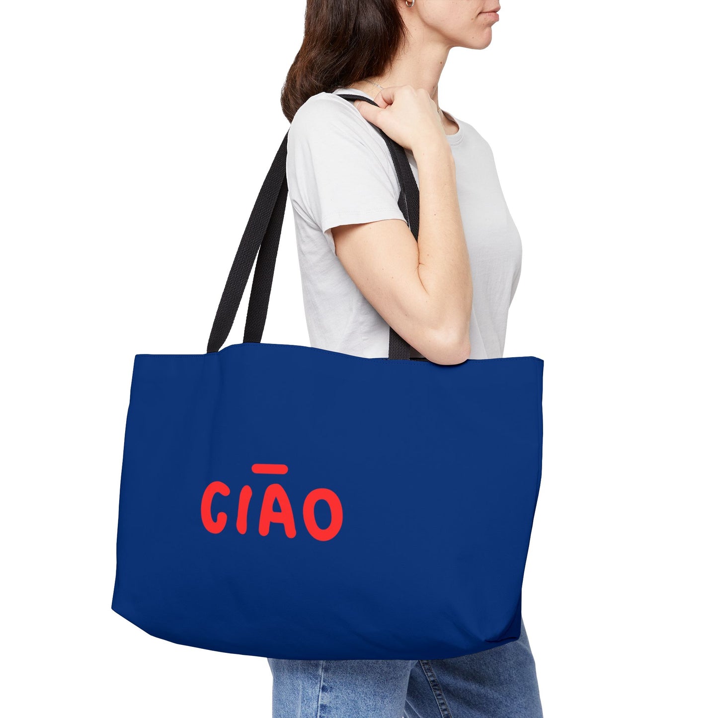 Person holding a blue tote bag with 'CIAO' printed on it against a white background