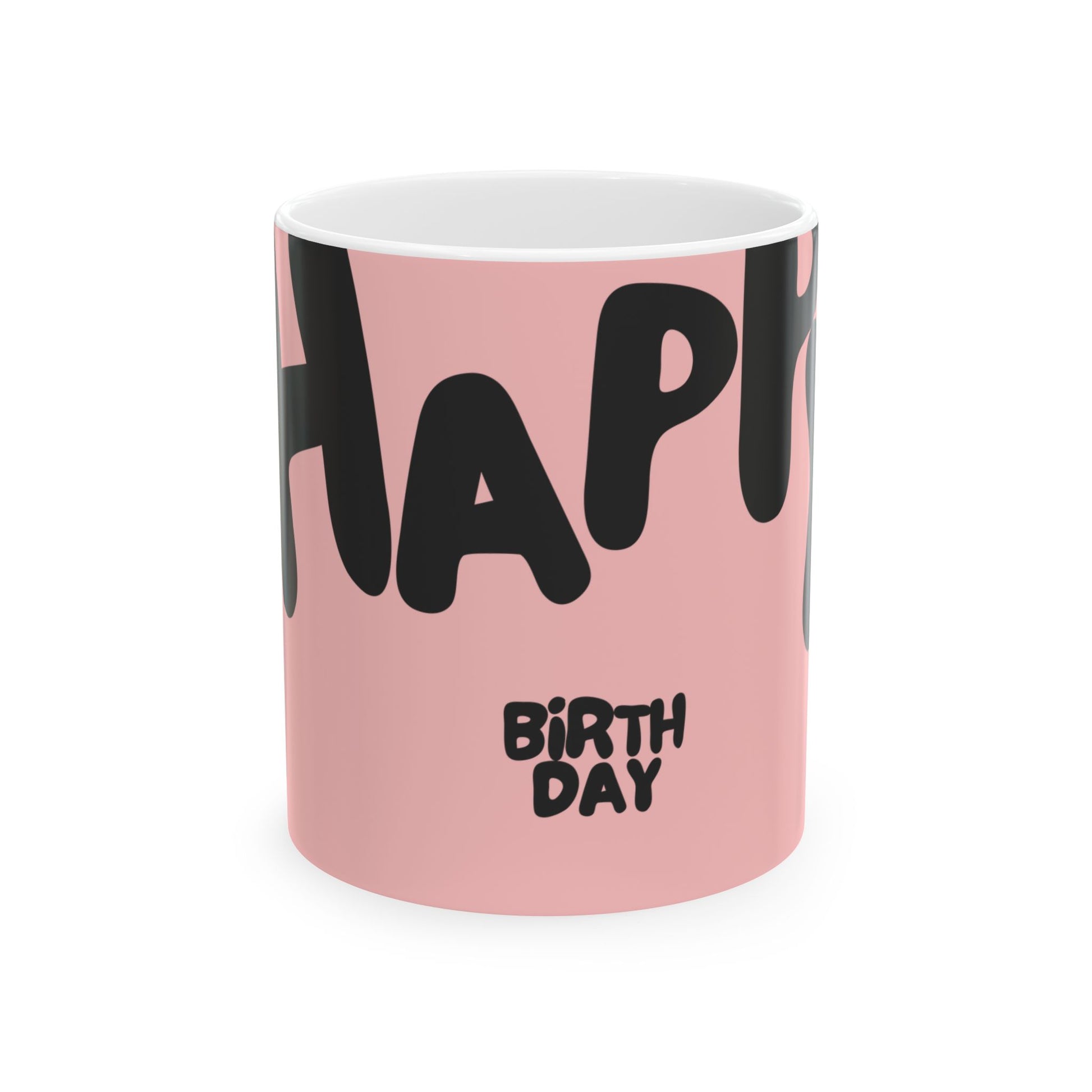 Pink mug with black text spelling 'Happy Birthday' on a white background