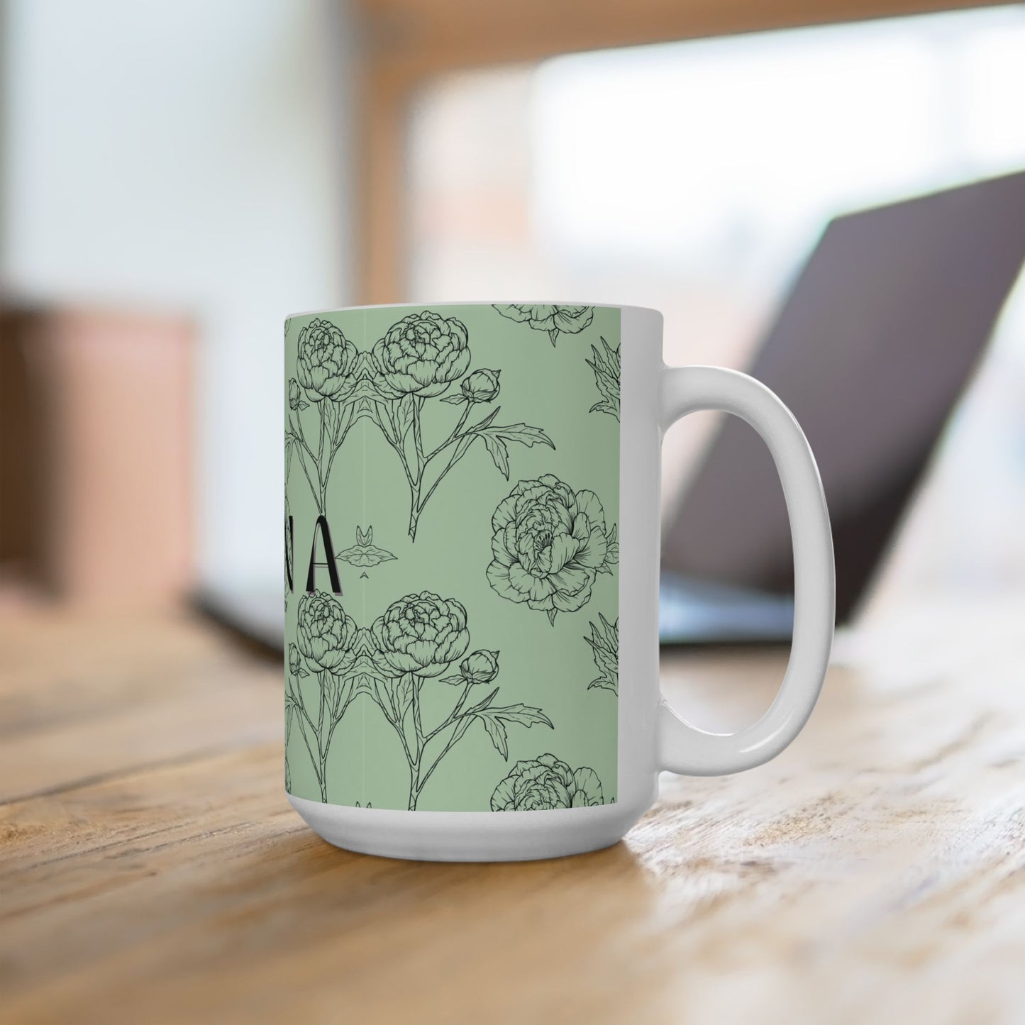 White mug with floral design on a light wooden surface