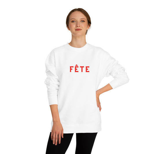 Person wearing a white sweatshirt with 'FèTE' printed in red on a white background