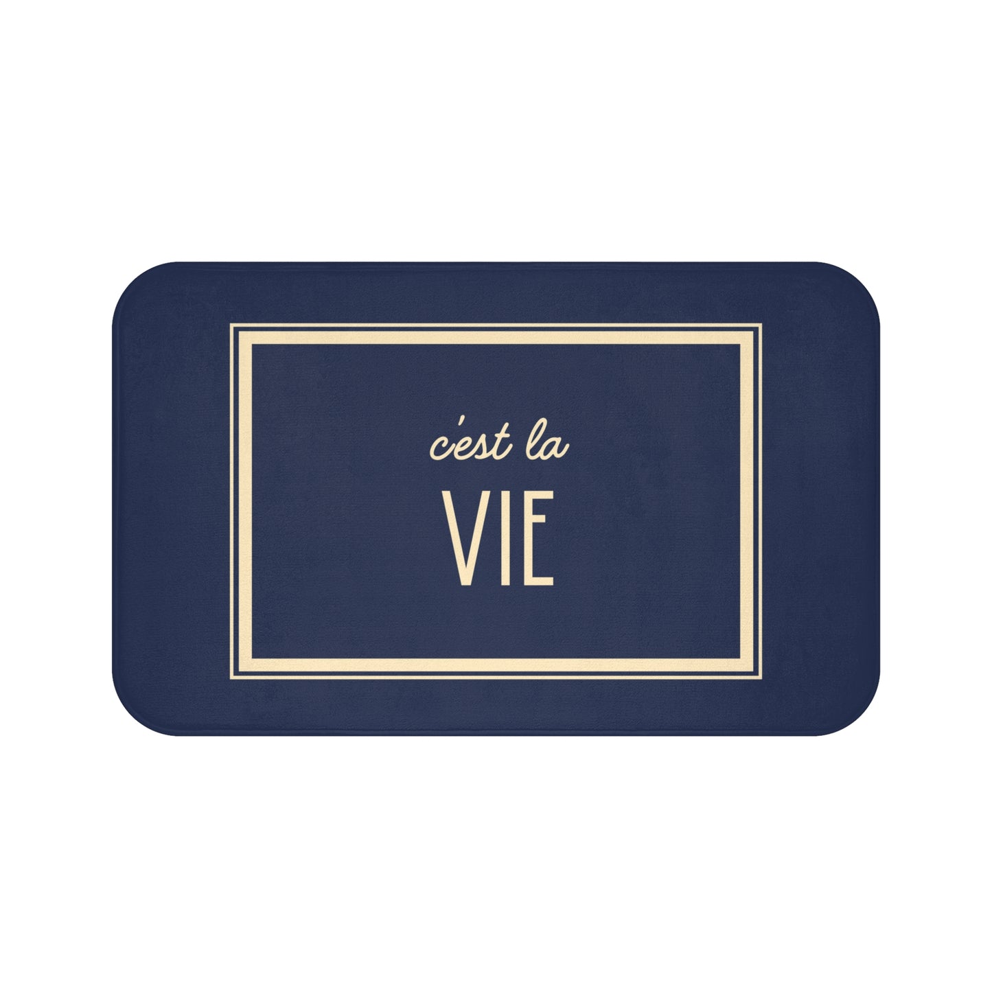 Navy blue placemat with 'c'est la Vie' text in gold on a white background