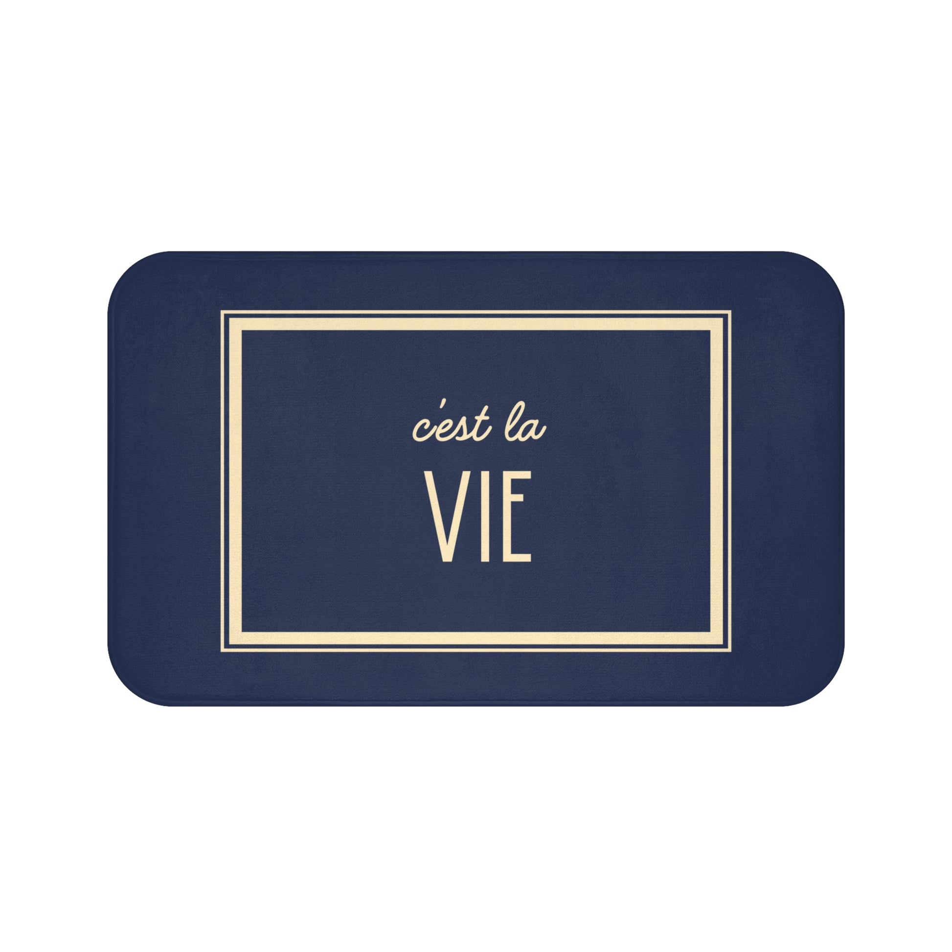 Navy blue placemat with 'c'est la Vie' text in gold on a white background
