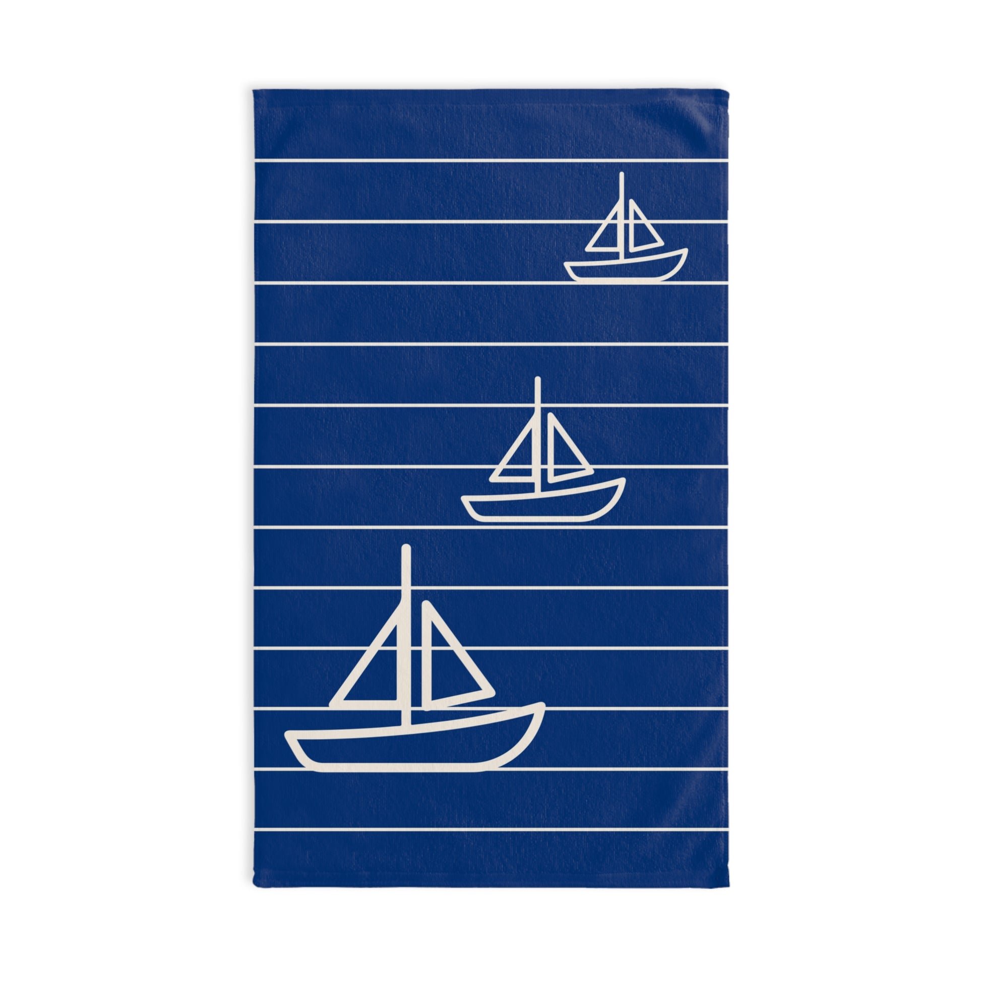 Blue towel with white sailboat patterns on a white background