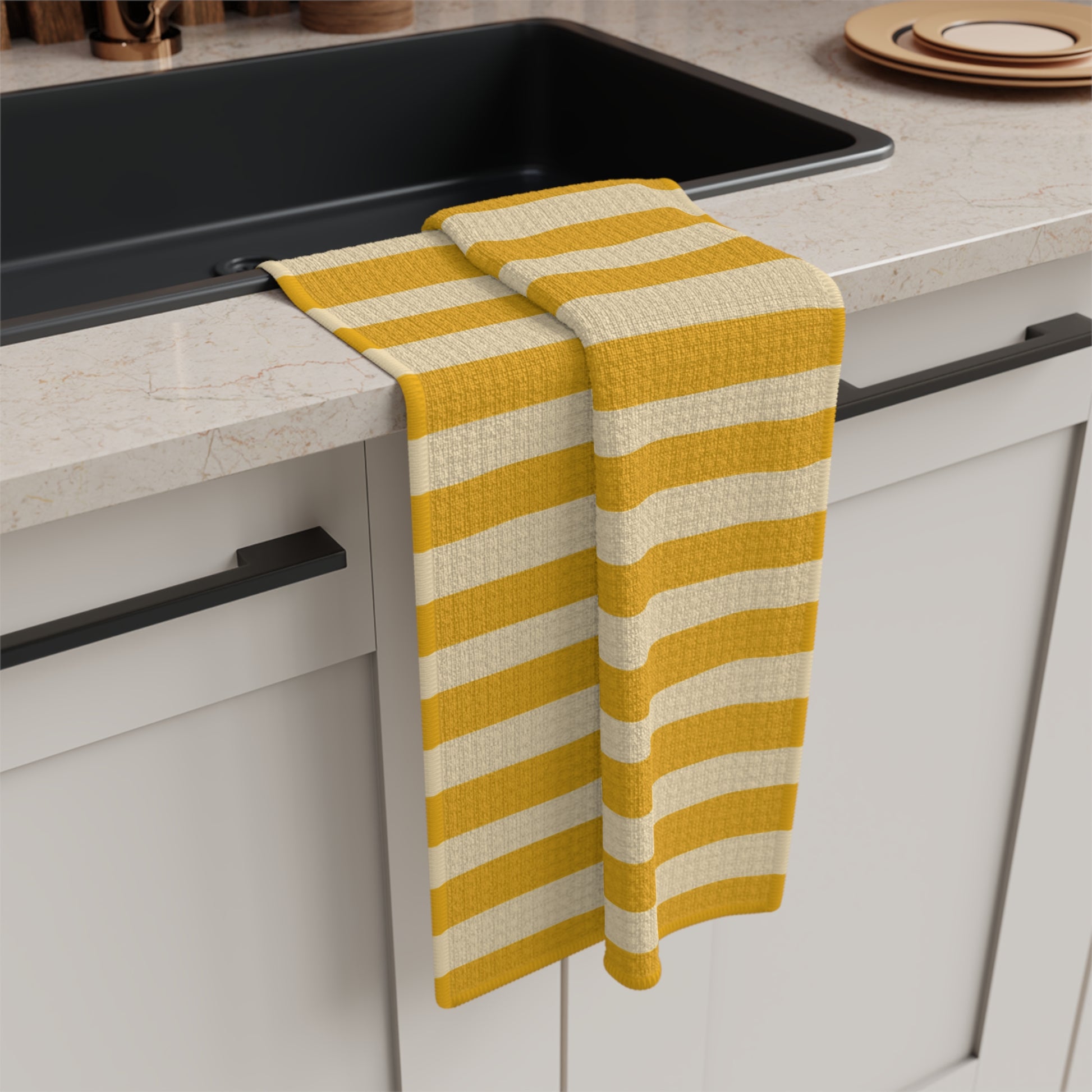 Yellow and white striped towel hanging on a kitchen cabinet handle.