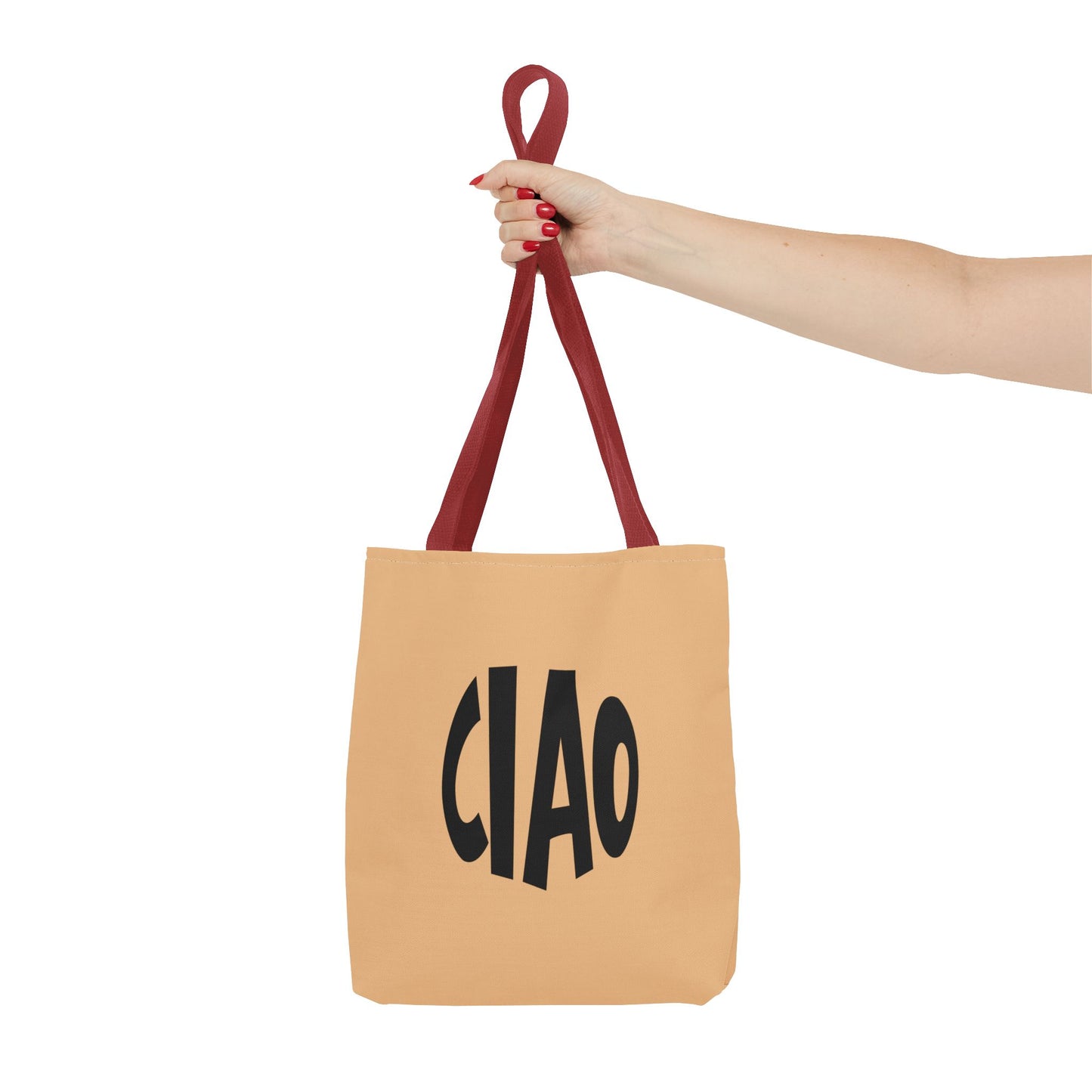 Beige tote bag with 'CIAO' text held by a hand with red nail polish on a white background