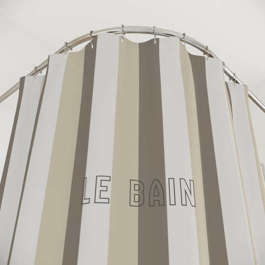 Striped shower curtain with 'LE BAIN' text on a neutral background