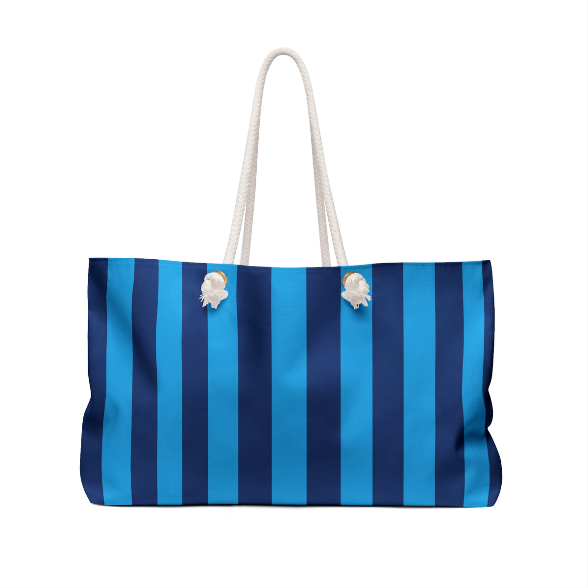A tote bag with vertical stripes in bright blue, medium blue, and navy blue, featuring off-white rope handles and two white shell-shaped decorative accents on the front.