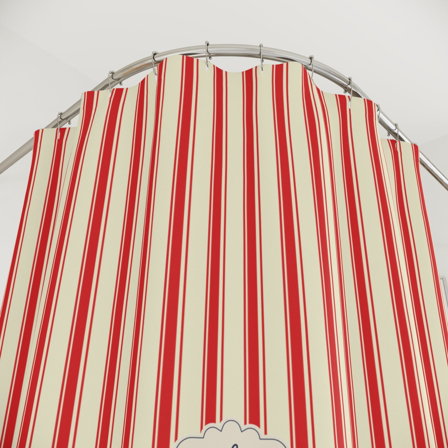 A red and cream striped fabric canopy or tent panel hanging from a curved metal rod against a plain light background.