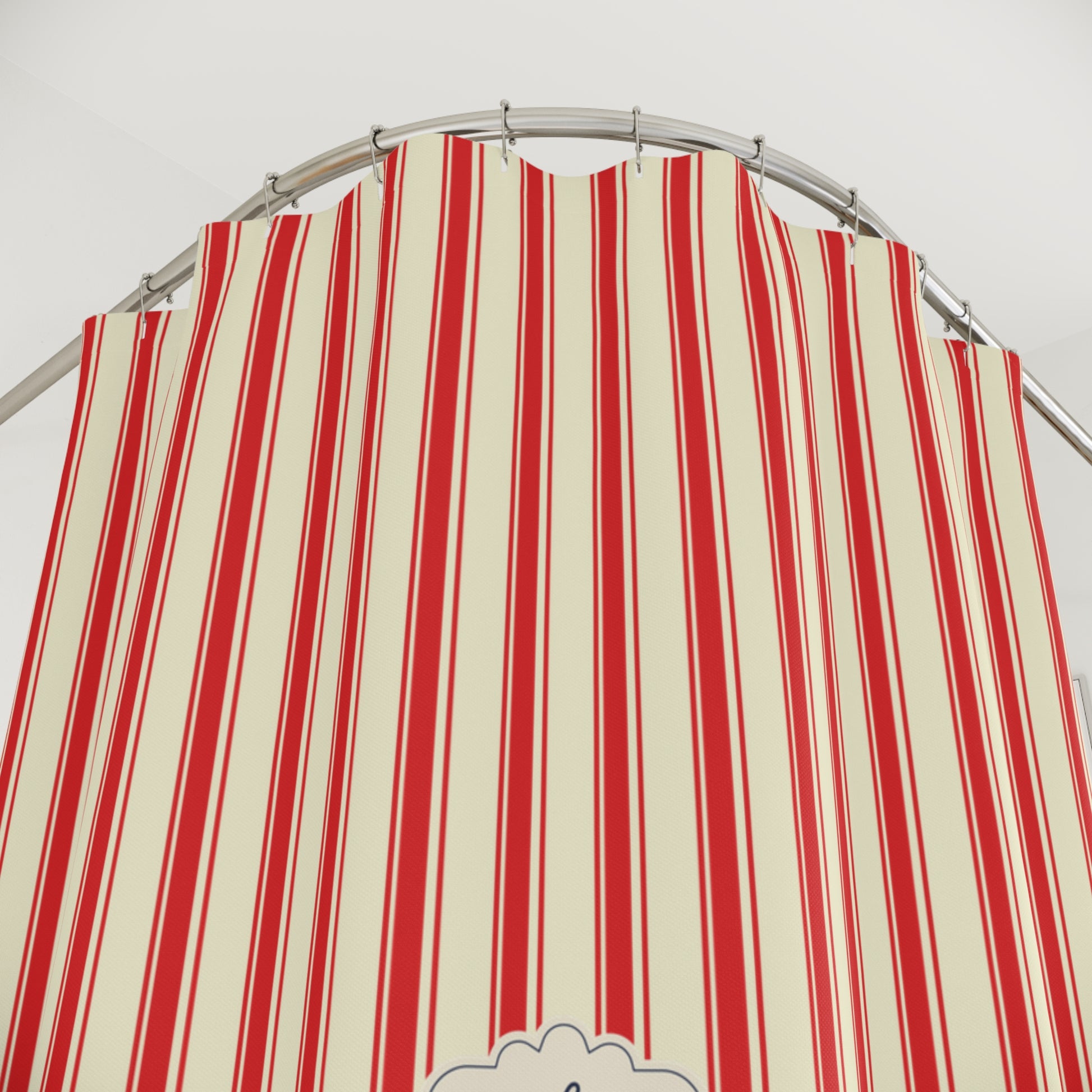 A red and cream striped fabric canopy or tent panel hanging from a curved metal rod against a plain light background.