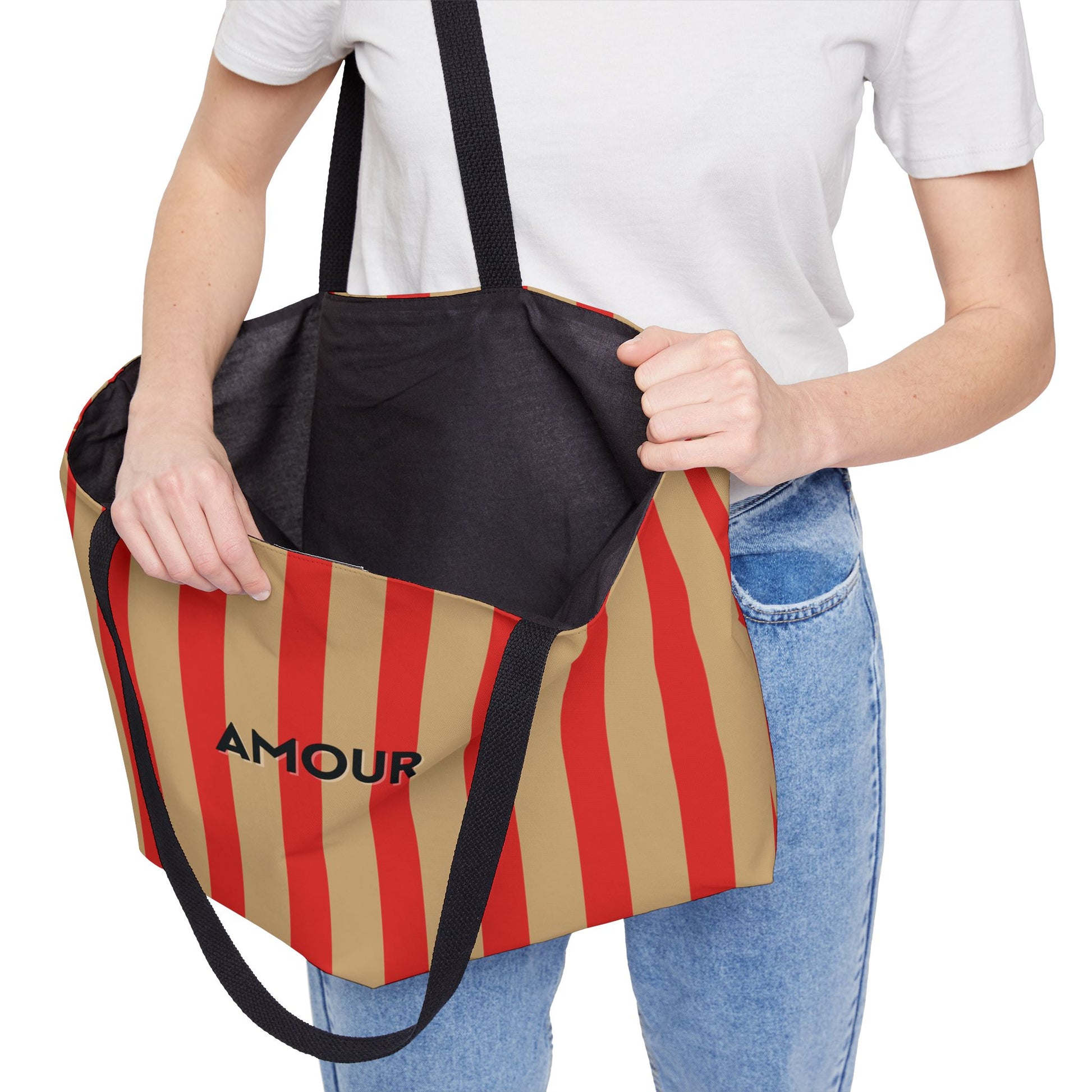 Person holding a striped bag with 'AMOUR' branding on a white background