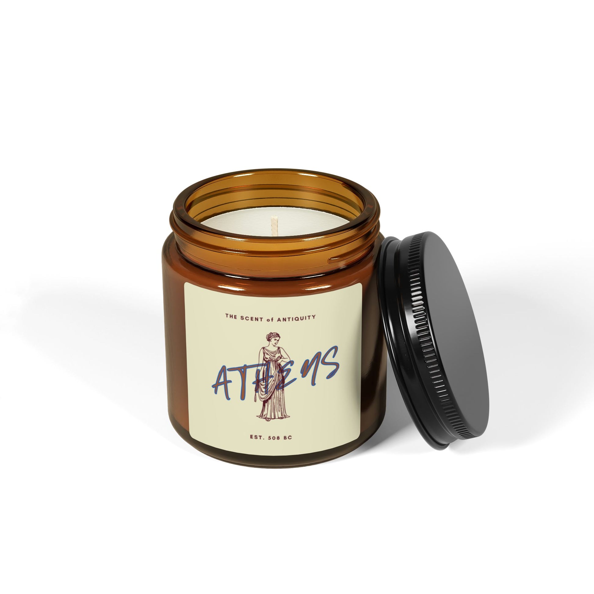 Candle in an amber jar with a label on a white background