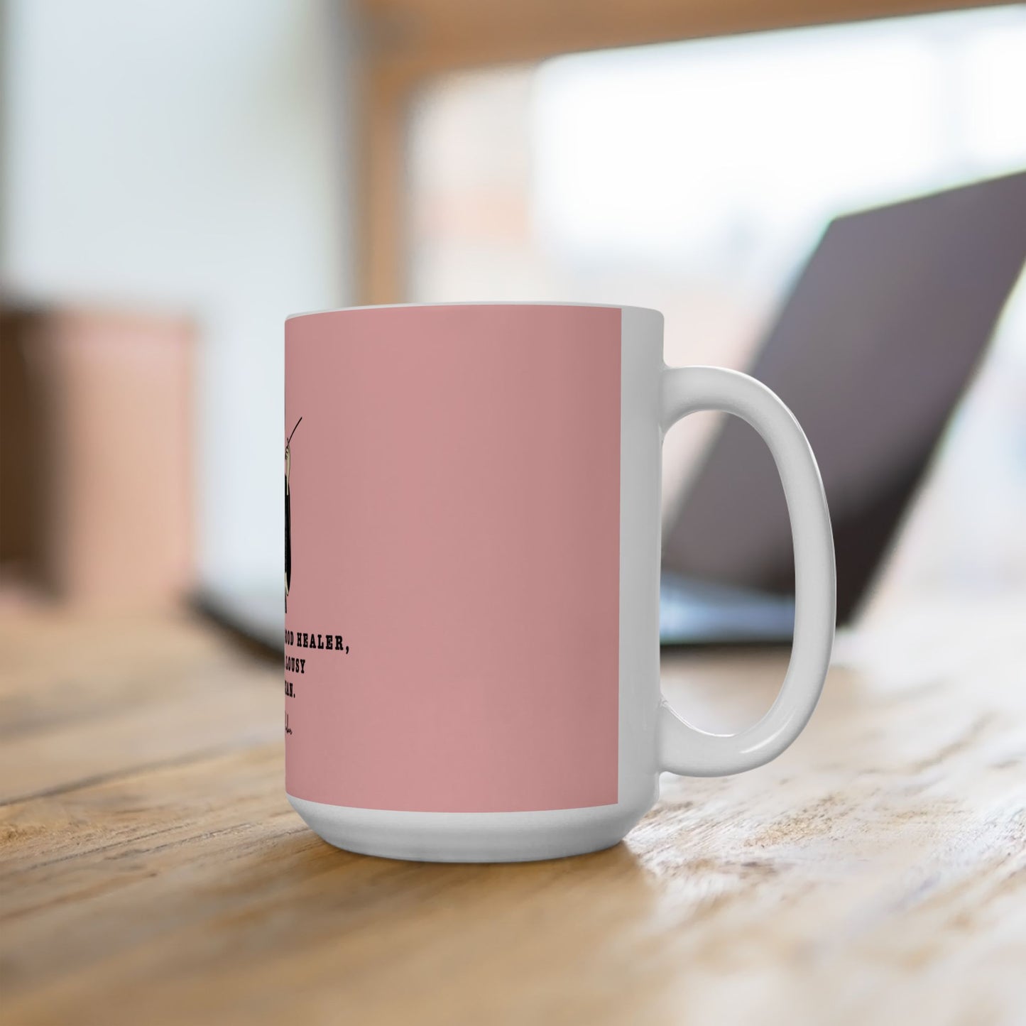 White mug with a pink accent on a wooden surface