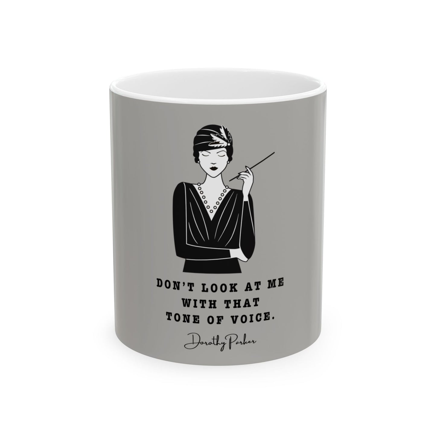 Gray mug with a black and white illustration of a woman and a quote on a white background