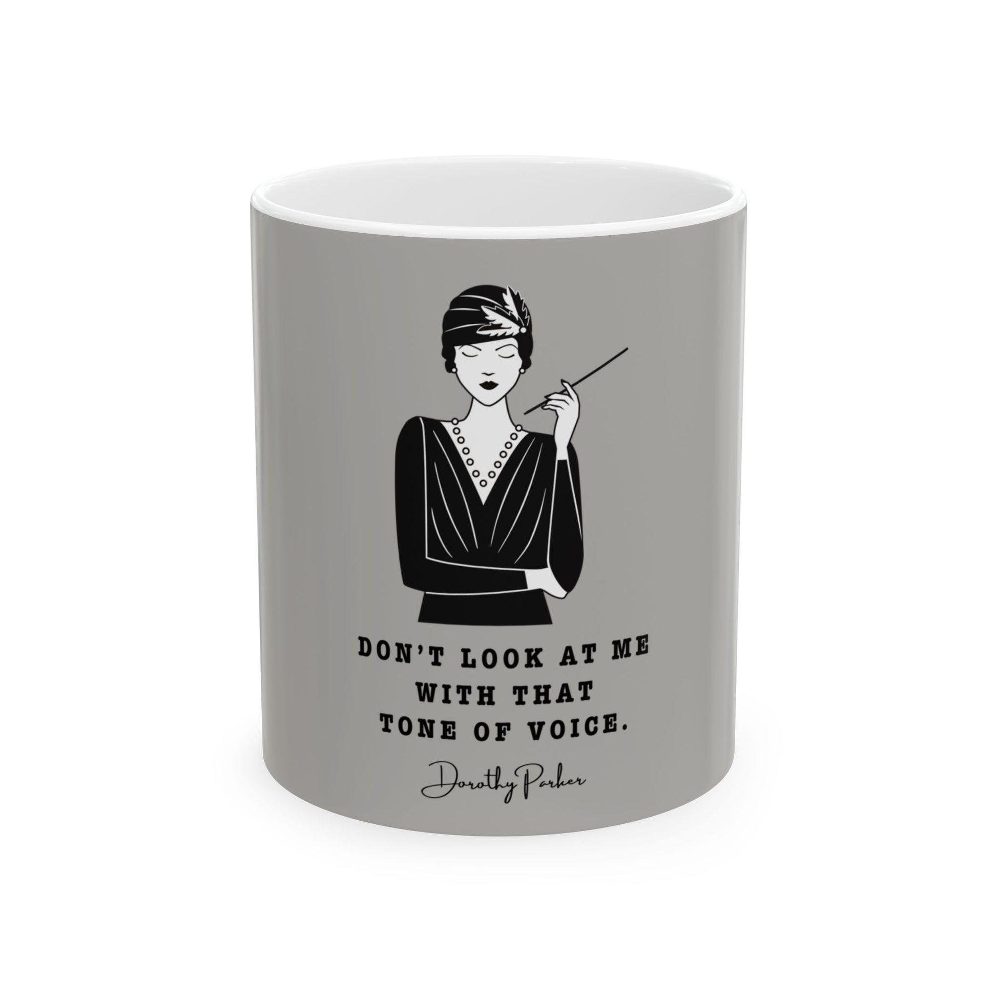 Gray mug with a black and white illustration of a woman and a quote on a white background