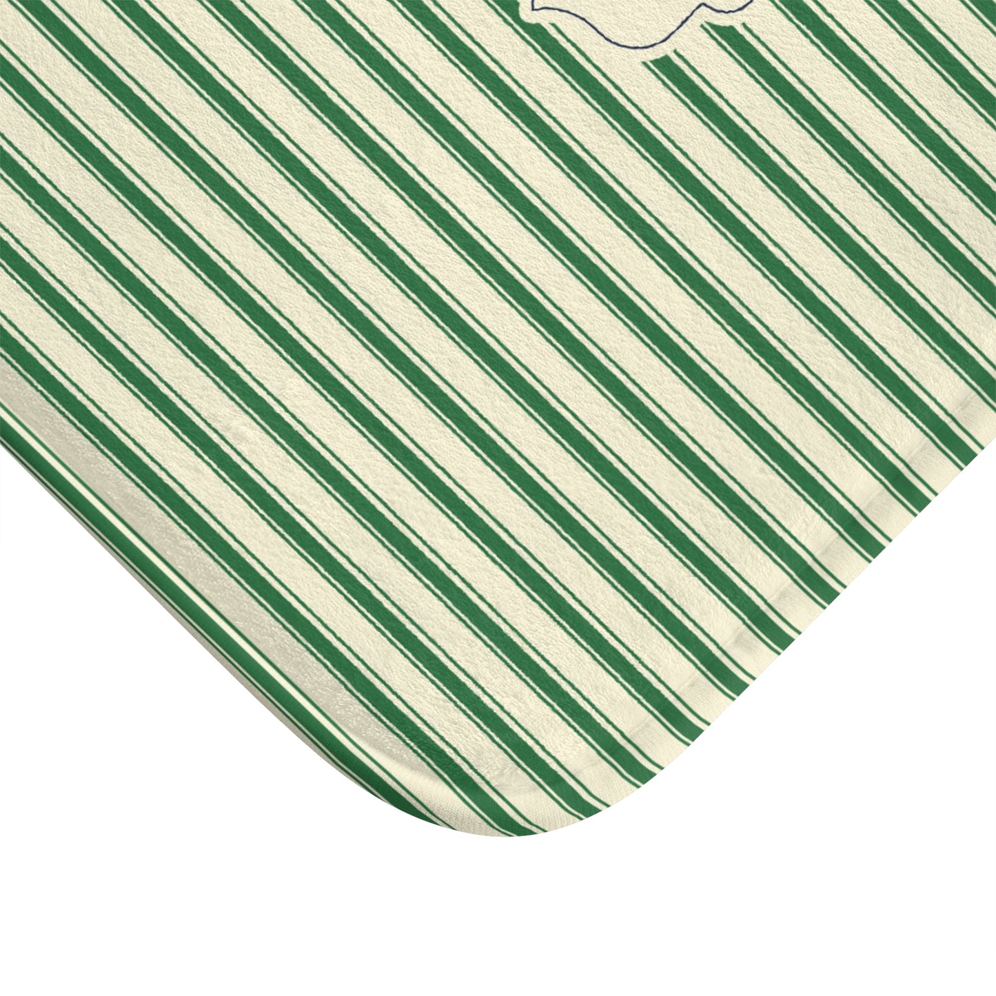 A close-up of a corner showing a fabric surface with diagonal stripes in dark green, medium green, and white, on a plain white background.
