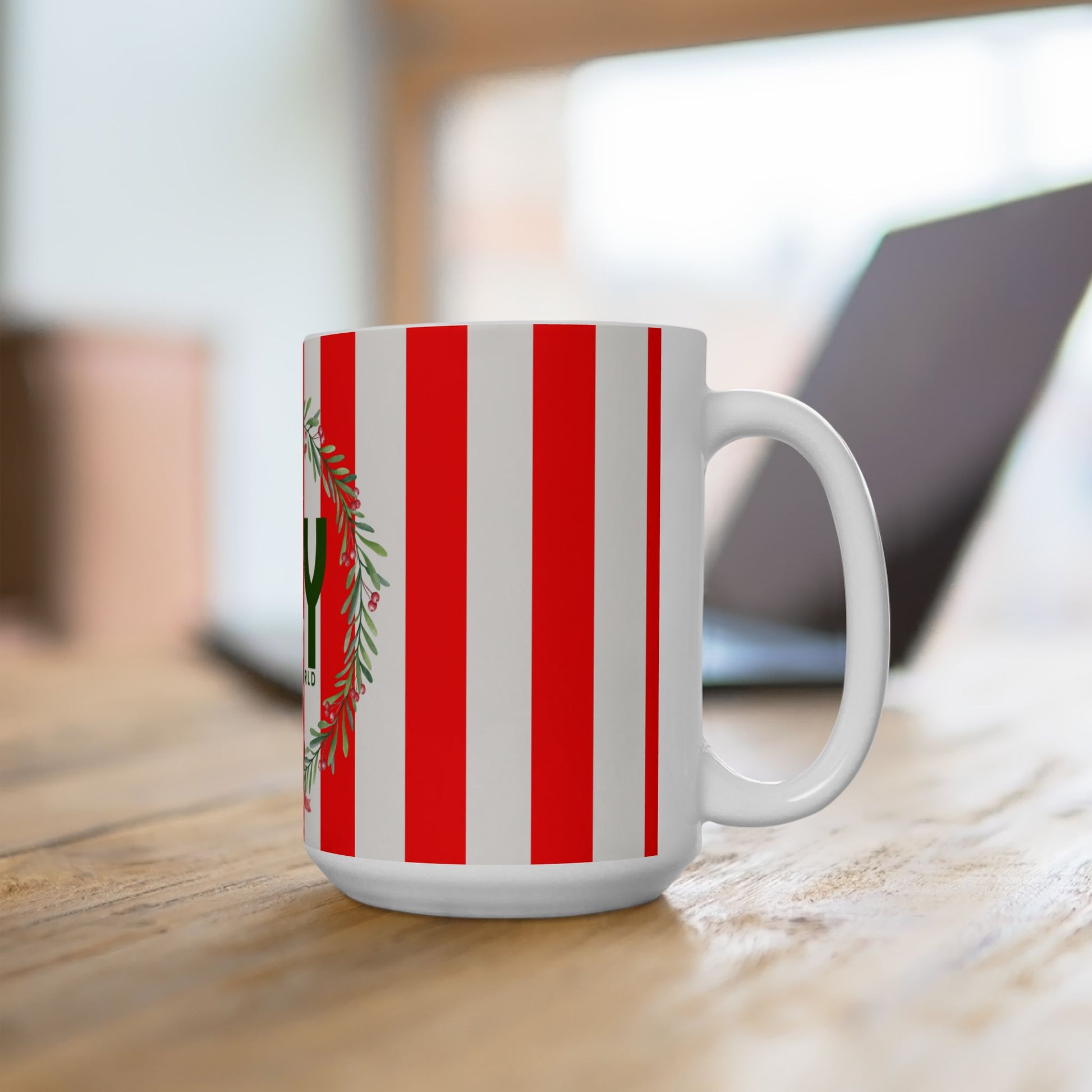 White mug with red and green striped pattern on a wooden surface